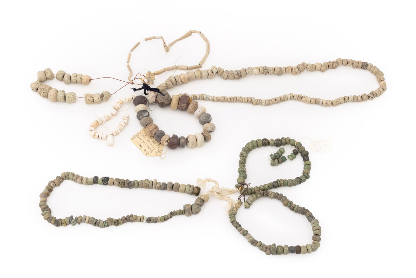 Collection of Pre-Columbian Carved Stone Beads: Collection of Pre-Columbian Carved Stone Beads, including jade beads and pumice beads. Largest bead: 0.75" L x 1.25" Diameter. Provenance: From the Estate of Jewelry Designer Irena Corwin. Keywords: