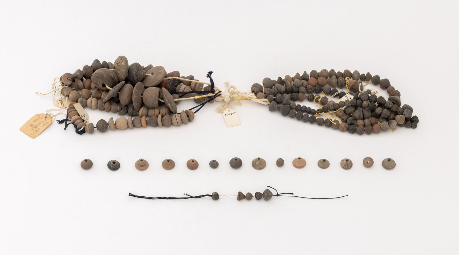 Collection of Pre-Columbian Pottery Beads: Collection of Pre-Columbian Pottery Beads, some with incised geometric decoration. Largest bead: 0.75" L x 2" Diameter. Provenance: From the Estate of Jewelry Designer Irena Corwin. Keywords: Clay,
