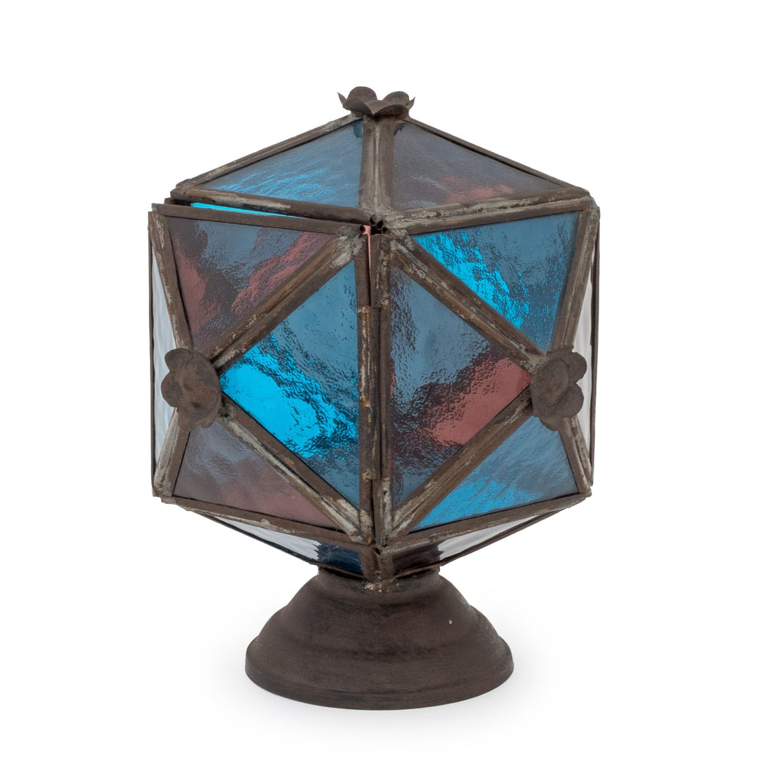American Stained Glass and Iron Lantern: American Stained Glass and Iron Lantern, blue and pink glass panels, floral motif to edges. 8" H x 6.5" W x 6.5" D. Provenance: From a 21 East 87th Street Estate. Keywords: Arts and Crafts, Table Lamp