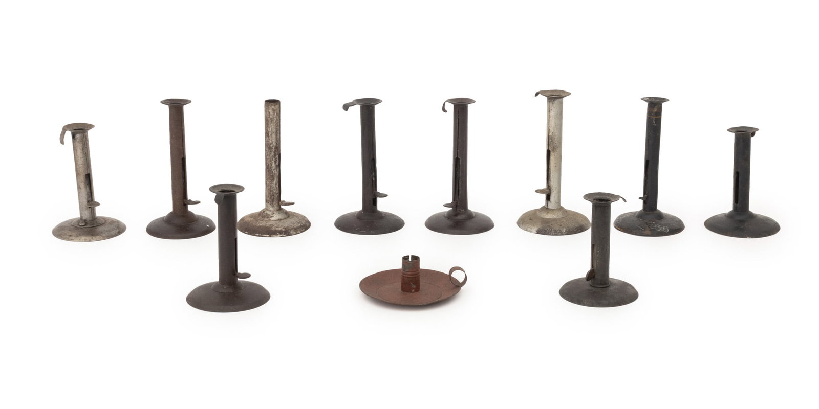 Collection of Antique Finger Chambersticks, 11: Collection of Eleven Antique Finger Chamber Sticks, all with push up ejectors except on red painted metal chamberstick. Tallest: 7.5" H x 4: Diameter. Provenance: From a 21 East 87th Street Estate.