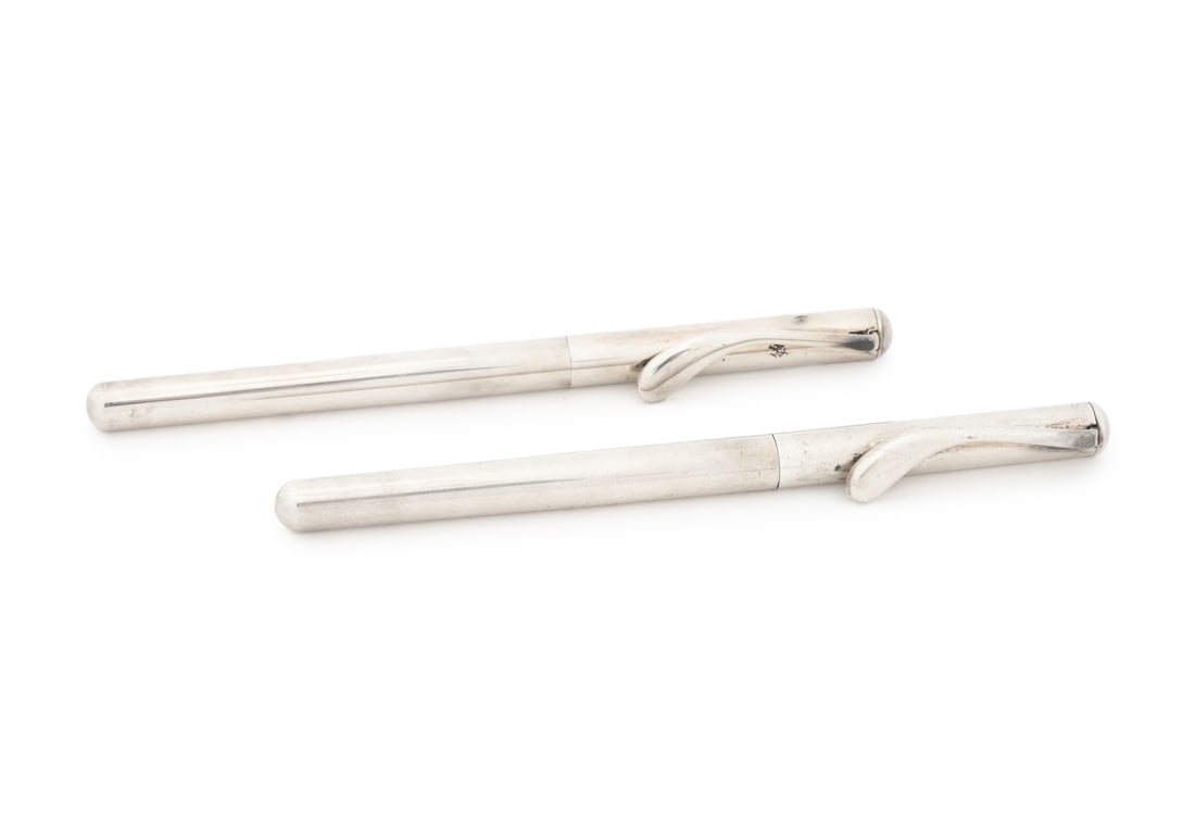 Peretti for Tiffany & Co. Silver Ballpoint Pens, 2: Pair of Elsa Peretti for Tiffany & Co. Sterling Silver Ballpoint Pens, marked "Tiffany & Co. / Peretti / 925" to the clip, with blue cloth draw string bag. Weight: 1.28 ozt.; 5" L. Provenance: From a 
