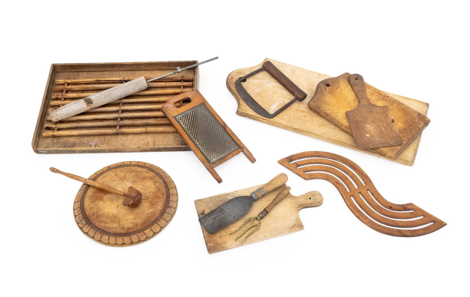Collection of American Primitive Kitchen Articles: Collection of American Primitive Kitchen Articles, including: cutting boards, utensils, trays, and a grater. Largest: 24" L x 9.75" W x 1" D. Provenance: From a 21 East 87th Street Estate. Keywords: A