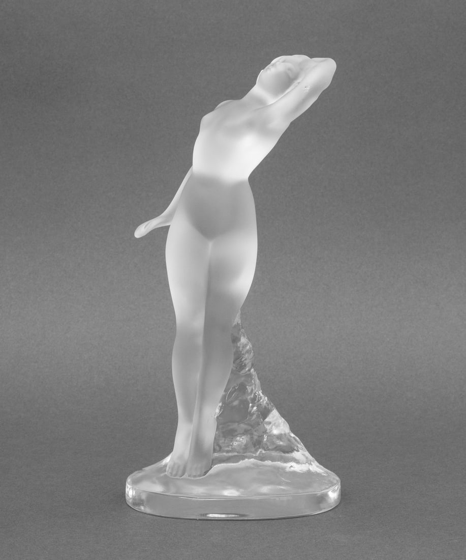 Lalique Crystal "Danseuse Bras Leves" Sculpture: Lalique "Danseuse Bras Leves" [Dancer with Arm Raised] Frosted and Clear Crystal Statue, signed "Lalique / France". 9.25" H x 5" W x 3.5" D. Provenance: From a New York City Collection. Keywords: