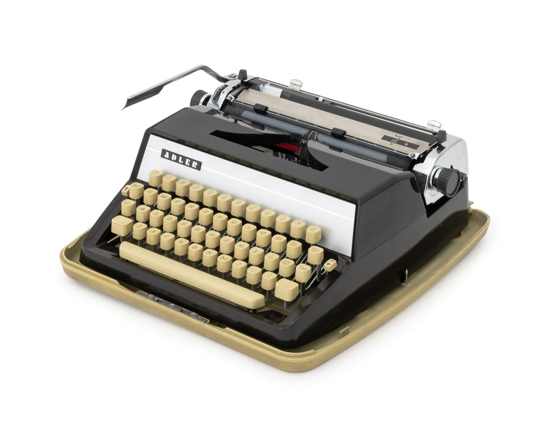 Adler J4 Portable Manual Typewriter: Adler J4 Portable Manual Typewriter, 1960s, in travel case. 14.5" L x 14" W x 6.5" D. Provenance: From the Estate of Gerard Stora, Vice President of Wildenstein Gallery. Keywords: Keyboard, Collectibl