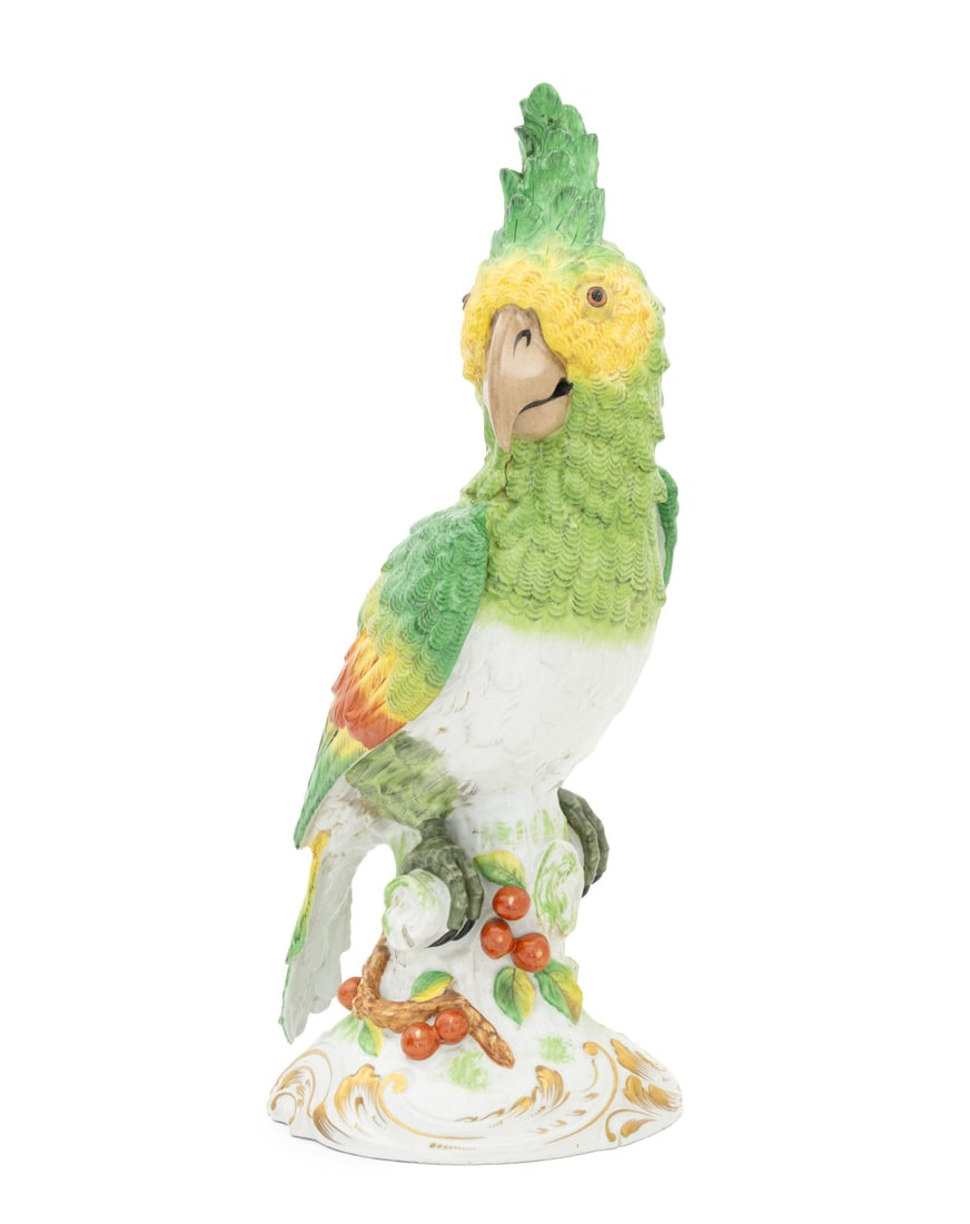 French Green Parrot Porcelain Sculpture: French Green Parrot Porcelain Sculpture, on gilt decorated tree-form base, "Porcelaine de Paris France" with crossed arrows mark underside. 21" GH x 10.5" W x 9" D. Provenance: From a West End Avenue