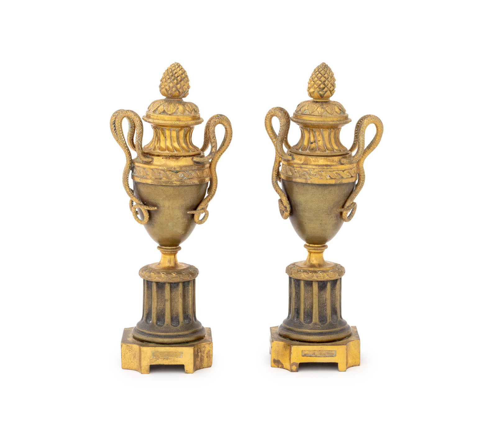 Louis XVI Style Ormolu Bronze Cassolettes, Pair: Pair of Louis XVI Style Ormolu Bronze Cassolette Candlesticks, each urn form with two serpent form handles above fluted column base, each cover with pinecone form finial. 8.5" H x 3.5" W x 2.5" D. Pro