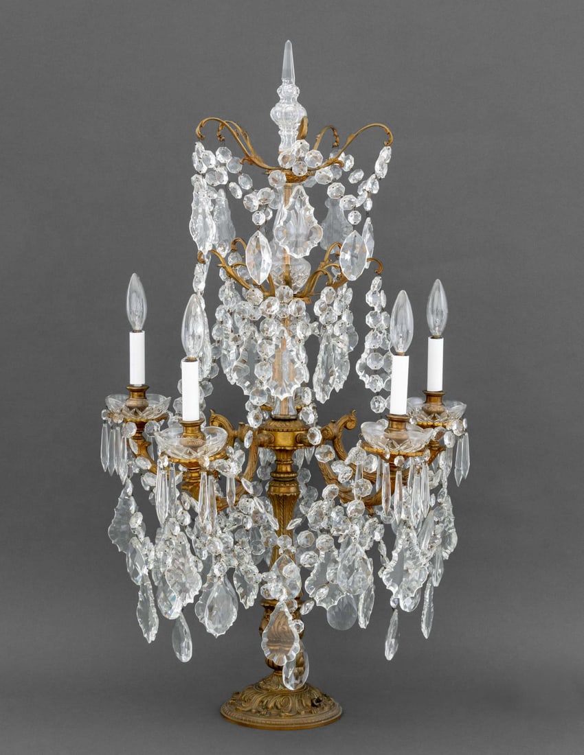 Louis XVI Style Brass and Crystal Lamp: Louis XVI Style Crystal and Brass Five-Branch Table Lamp, candlestick style sockets, dangling crystal prisms, crystal finial. 38.5" H x 21" Diameter. Provenance: From a West End Avenue Collection. Key