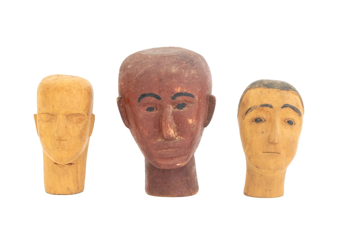 South American Carved Wood Santos Doll Heads, 3: Collection of Three South American Carved Wood Santos Doll Heads, one painted red. Largest: 8.75" H x 6" W x 6" D. Provenance: From an East 86th Street Estate. Keywords: Folk Art, Religious Art, Carvi