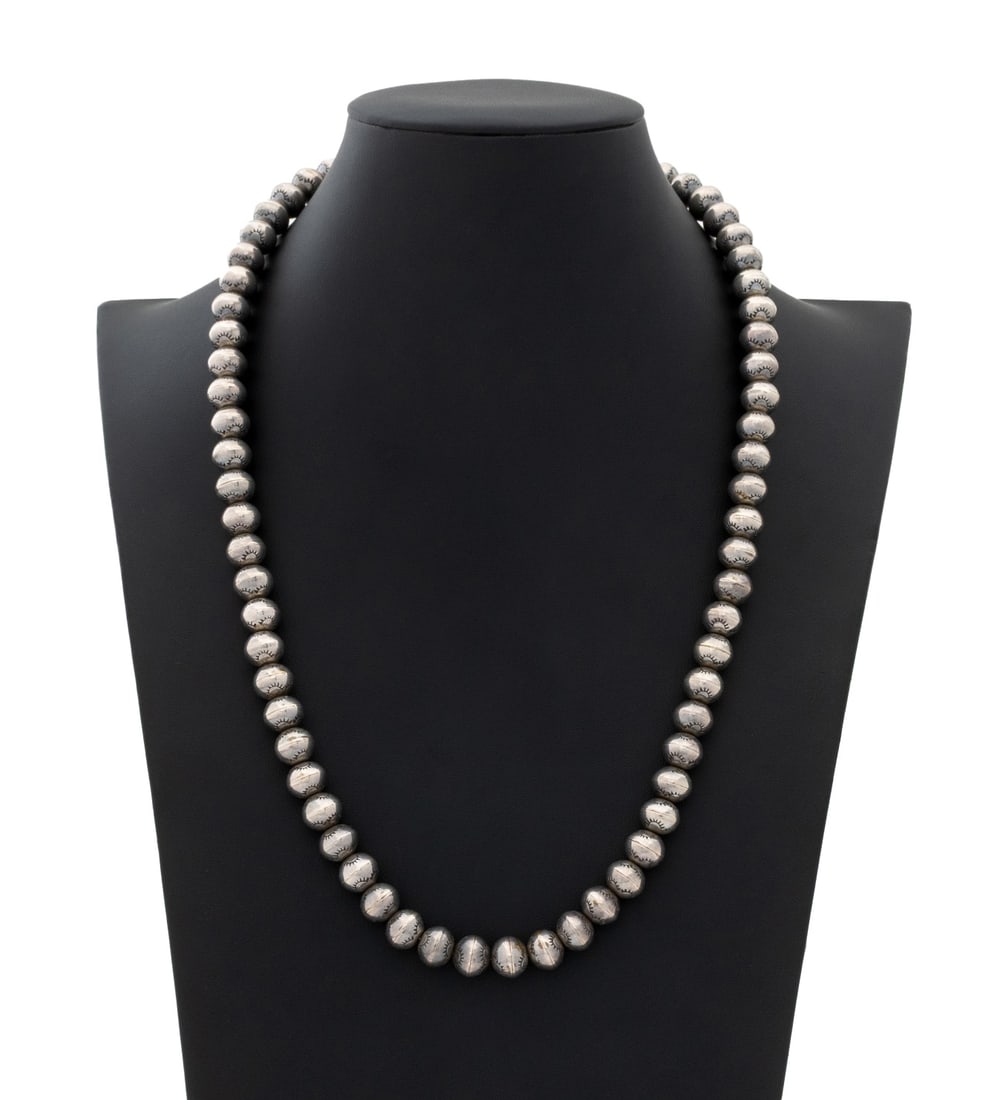 Navajo Dine Sterling Silver Bead Necklace: Navajo Dine Sterling Silver Bead Necklace, featuring round silver beads decorated with stampwork approx. 10.5 - 11.0 mm., worn with sterling silver chain necklace joined by hook and eye clasp,