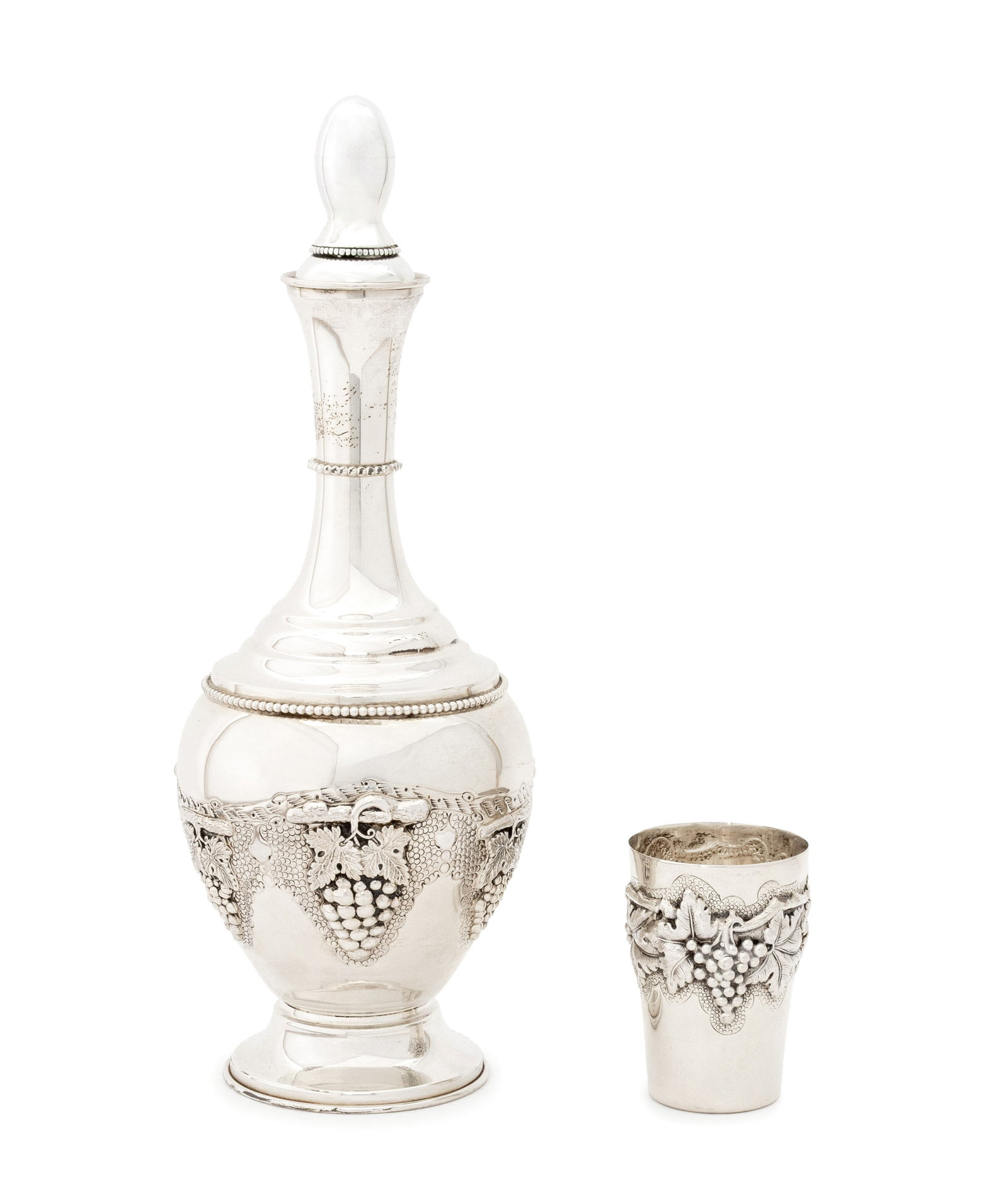 Judaica Silver Decanter and Kiddush Cup: Judaica Silver Decanter and Kiddush Cup, with repousse grapevine motif, the decanter marked "Sterling" to base and kiddush cup marked "0.833 / Made in Portugal" to underside. Weight: 18.54 ozt.; 13" H