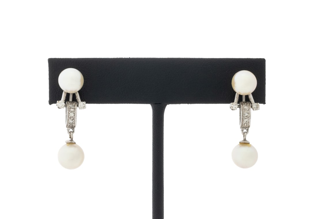 Pearl and Diamond White Gold Drop Earrings: Pair of 14K White Gold Pearl and Diamond Earrings, featuring four round cultured pearls approx. 7.0 - 8.0 mm, further adorned with ten prong set round faceted diamonds weighing a total of approx. 0.30