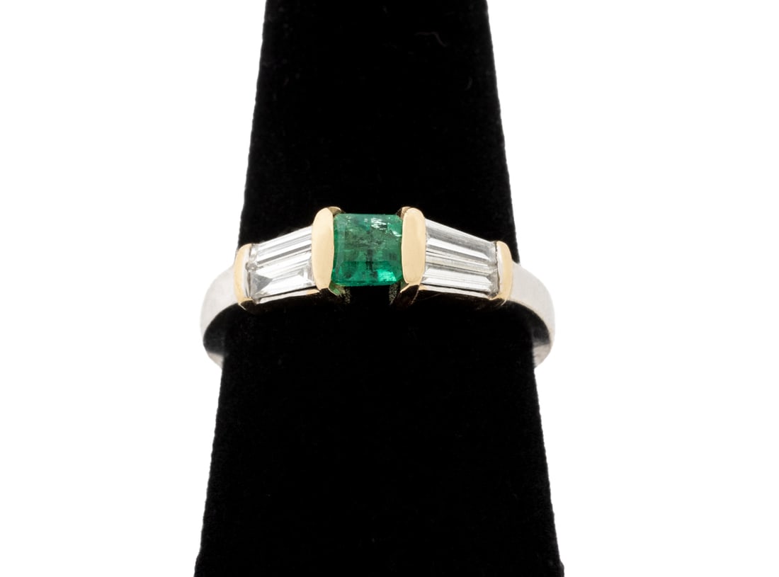 Emerald and Diamond Yellow Gold Ring: Emerald and Diamond 14K Yellow Gold Ring, featuring one channel set square emerald cut emerald weighing approx. 0.40 carat, further adorned with six channel set baguette cut diamonds weighing a total 