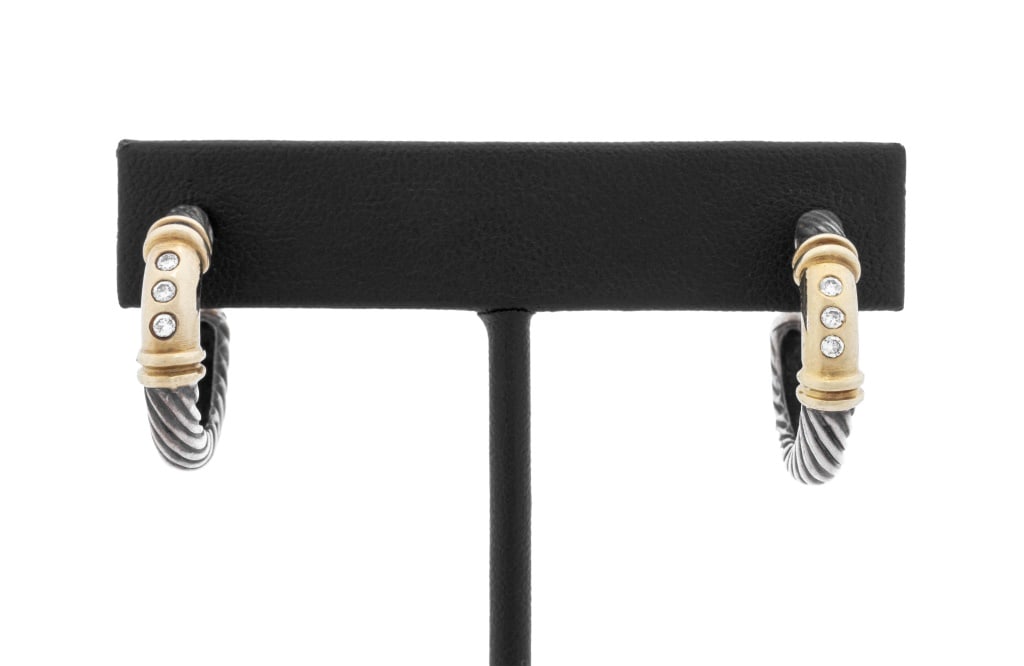 David Yurman Silver & Gold Diamond Huggie Earrings: Pair of David Yurman Sterling Silver and 14K Yellow Gold Diamond Huggie Earrings, featuring six flush set round brilliant cut diamonds weighing approx. 0.15 carat, worn through pierced earlobe with po