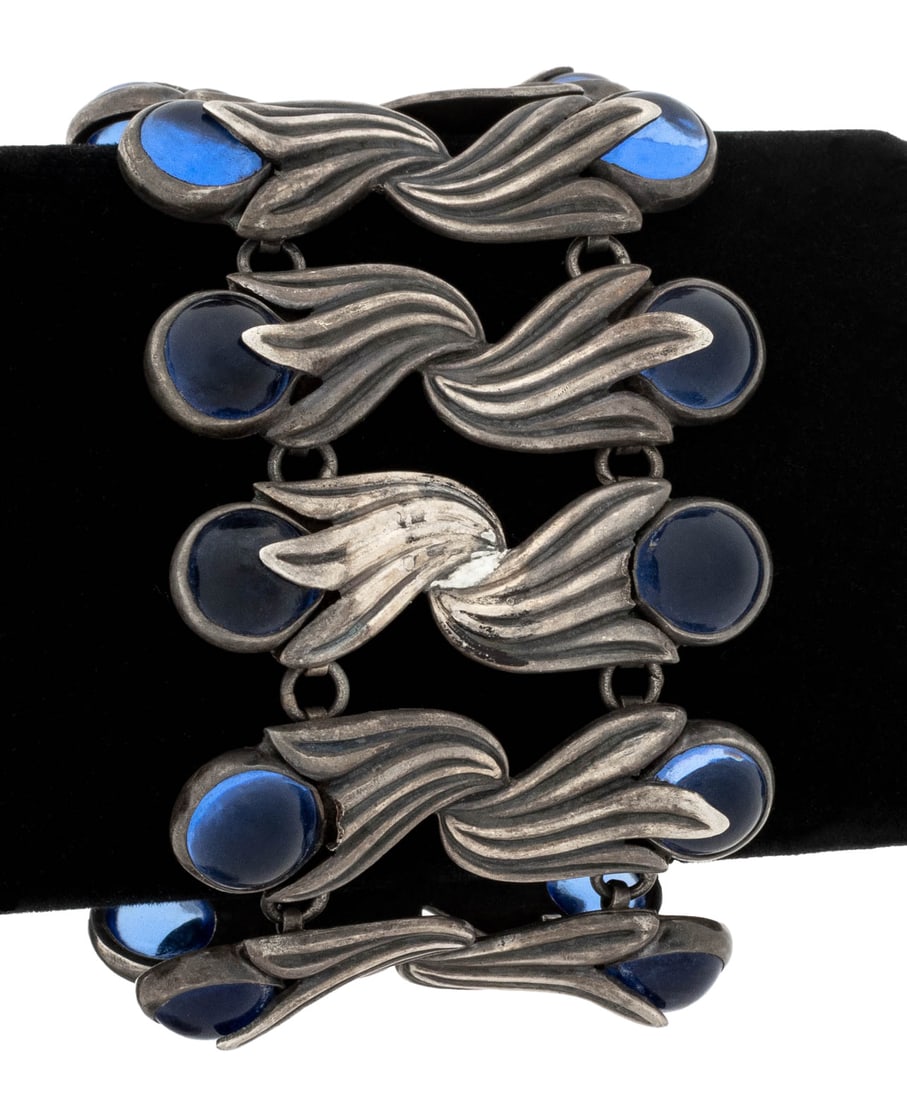 Los Castillo Taxco Silver Blue Gripoix Bracelet: Los Castillo Taxco 920 Silver Blue Glass Bracelet, designed as tulip shaped links, decorated with twenty bezel set round blue glass cabochons approx. 10.0 mm, joined with hook and eye clasp and fixed 