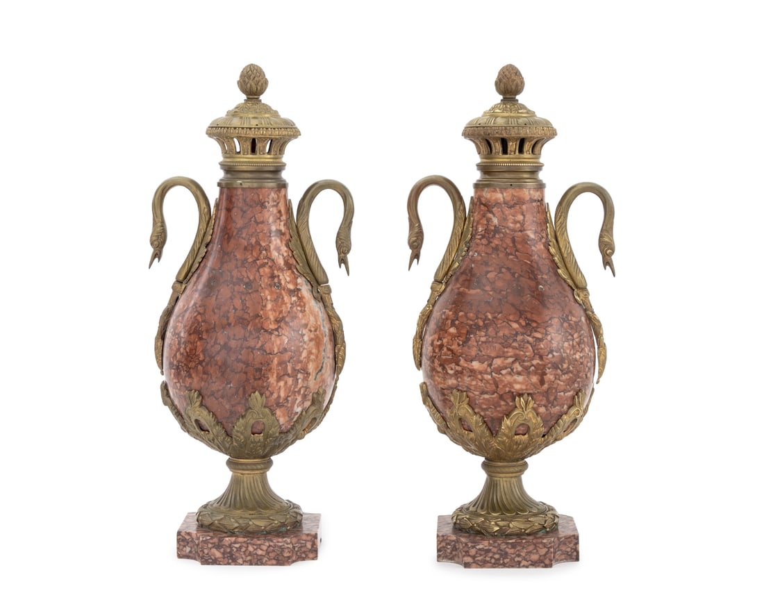 French Ormolu Mounted Rouge Griotte Urns, Pair: Pair of French Neoclassical Style Ormolu Mounted Rouge Griotte Urn Forms, each with two swan head form handles. 20.75" H x 8.5" W x 7.5" D. Provenance: From an East 35th Street Estate. Keywords: Red M