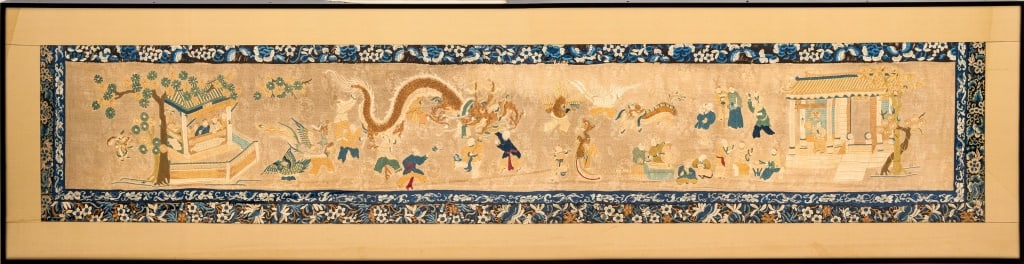 Chinese Lunar New Year Festival Silk Embroidery: Chinese Lunar New Year Festival Silk Embroidery, depicting an outdoor scene with dragon dancers and people celebrating, blue floral motif border, dragon composed of fine gold-tone beads, ebonized fram