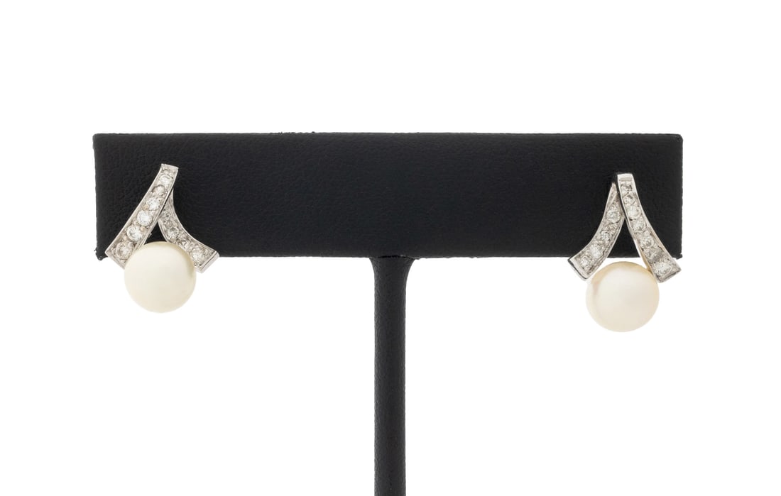 Modern White Gold Pearl and Diamond Earrings: Pair of Modern 14K White Gold Cultured Pearl and Diamond Earrings, decorated with two round cultured pearls approx. 7.8 mm., further adorned with twenty two pave set round brilliant cut diamonds weigh