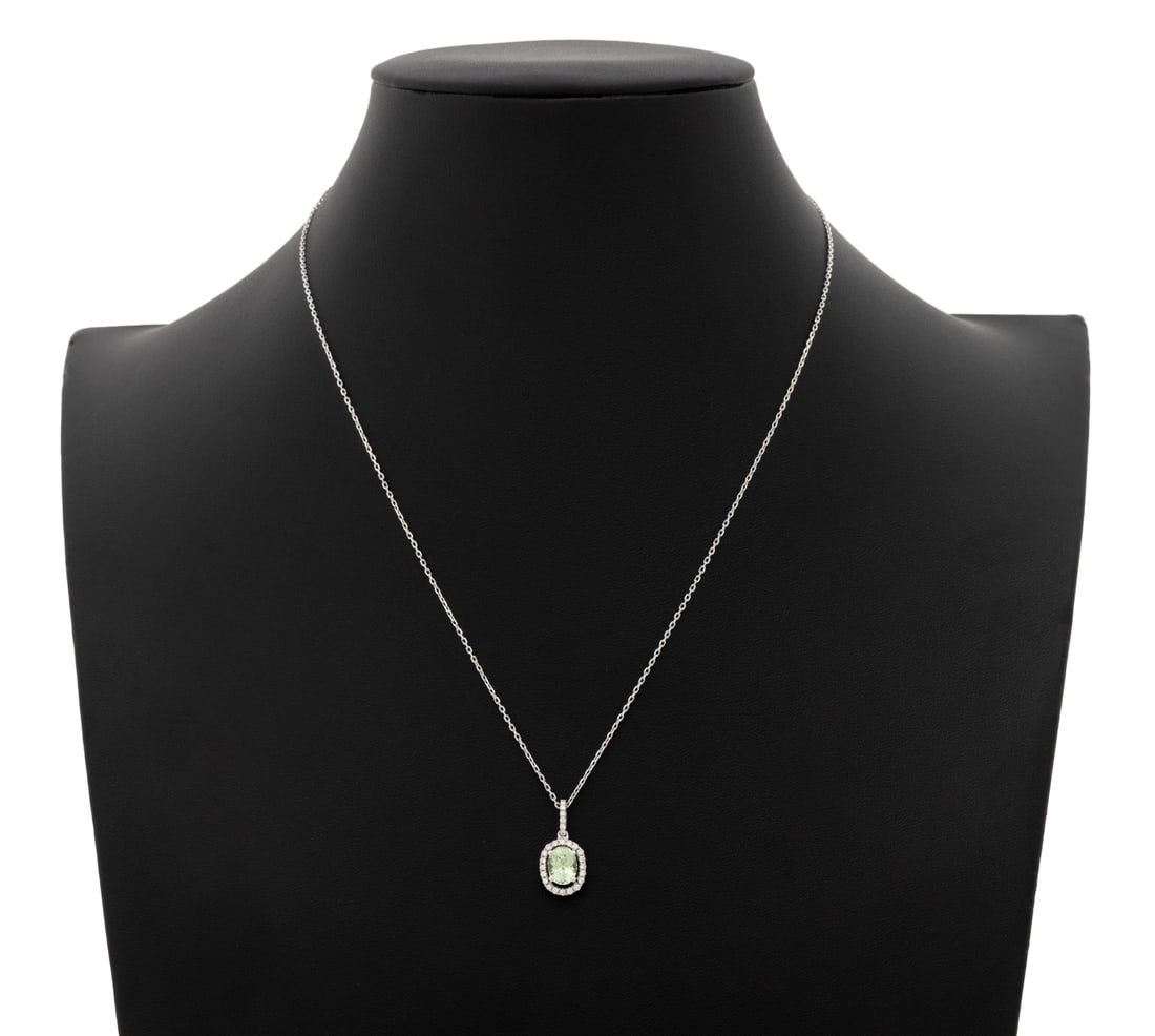 Modern Peridot Diamond White Gold Pendant Necklace: Modern 18K White Gold Peridot Diamond Pendant on 14K White Gold Necklace, featuring one prong set oval brilliant cut peridot weighing approx. 1.25 carats, further adorned with 27 prong set round brill