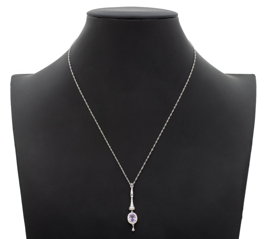 Modern 18K White Gold Amethyst Pendant Necklace: Modern 18K White Gold Amethyst Pendant Necklace, featuring one detachable pendant decorated with one centered prong set oval brilliant cut amethyst weighing approx. 0.75 carat, further decorated with 