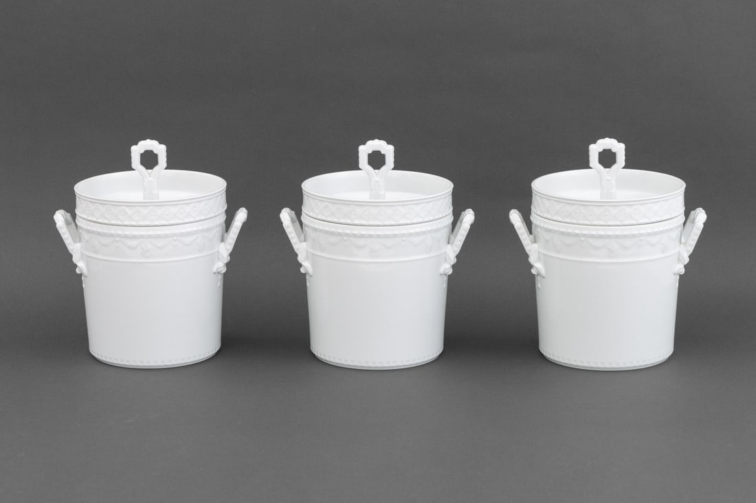 KPM "Kurland" White Porcelain Ice Buckets, 3: Set of Three KPM Berlin "Kurland" Pattern Blanc de Chine Porcelain Ice Buckets, each cover and pail with blue underglaze scepter marks. Overall: 11.5" H x 9.75" W x 7.5" D. Provenance: From a 500 Park