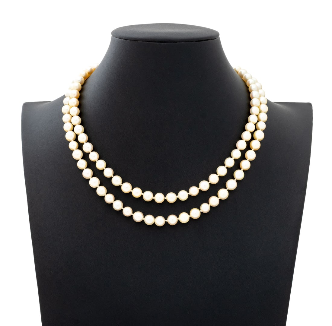 White Gold Diamond Clasp Cultured Pearl Necklace: 14K White Gold Diamond Clasp Cultured Pearl Necklace, featuring fully drilled round cultured pearls approx. 7.0 - 7.5 mm., strung on silk cord, knotted between each pearl, joined with 14K white gold b