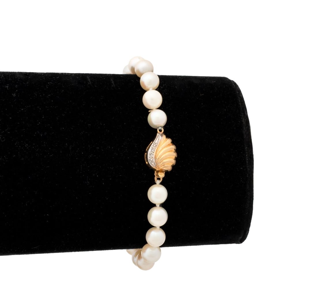 Yellow Gold and Diamond Cultured Pearl Bracelet: 14K Yellow Gold and Diamond Cultured Pearl Bracelet, featuring fully drilled round cultured pearls approx. 6.5 - 7.0 mm, strung on silk cords and knotted between each pearl, joined with box and tongue
