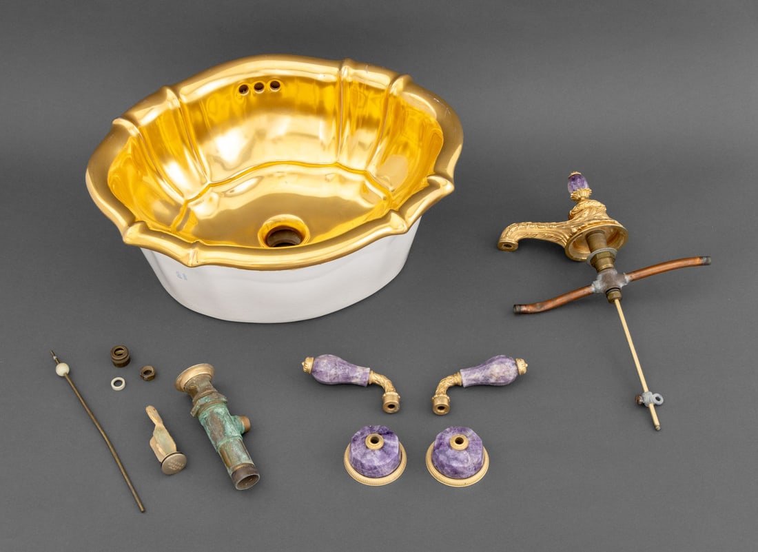 Sherle Wagner Porcelain Scalloped Over Edge Sink: Sherle Wagner Gilt Porcelain Scalloped Over Edge Sink, with bronze amethyst faucet and handles, copper and brass hardware set, marked "Sherle Wagner / Italy". Sink: 8.25" H x 19.5" W x 16" D. Provenan