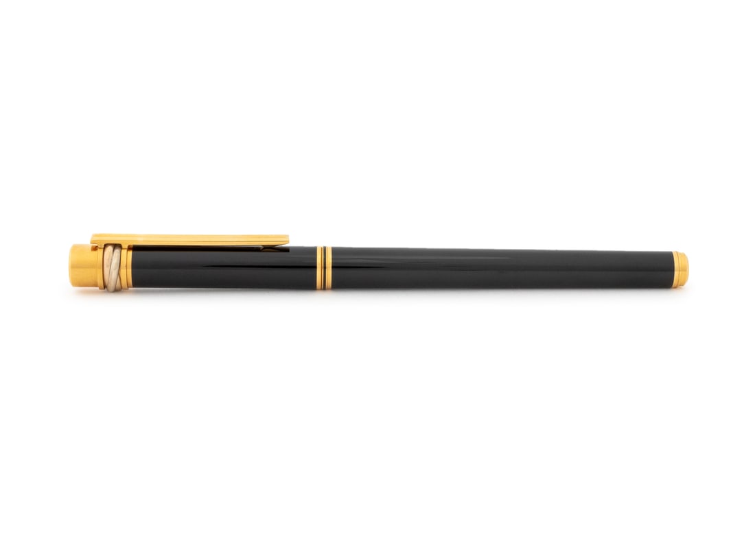 Cartier "Must de Cartier" Fountain Pen: Cartier "Must de Cartier" Fountain Pen, black case, gold-plate accents, with Cartier trinity rings, 18K gold nib marked with Cartier logo and "18K / 750", with label "M", marked "Must de Cartier" to t