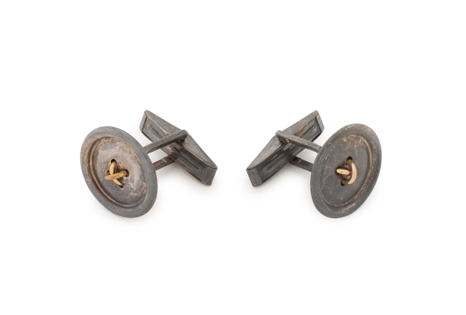 Tiffany & Co. Sterling and Gold Button Cufflinks: Tiffany and Company Sterling Silver and Yellow Gold Button Form Cufflinks, designed as round buttons with four holes, crafted in sterling silver with centered 14K yellow gold threads, brightly polishe