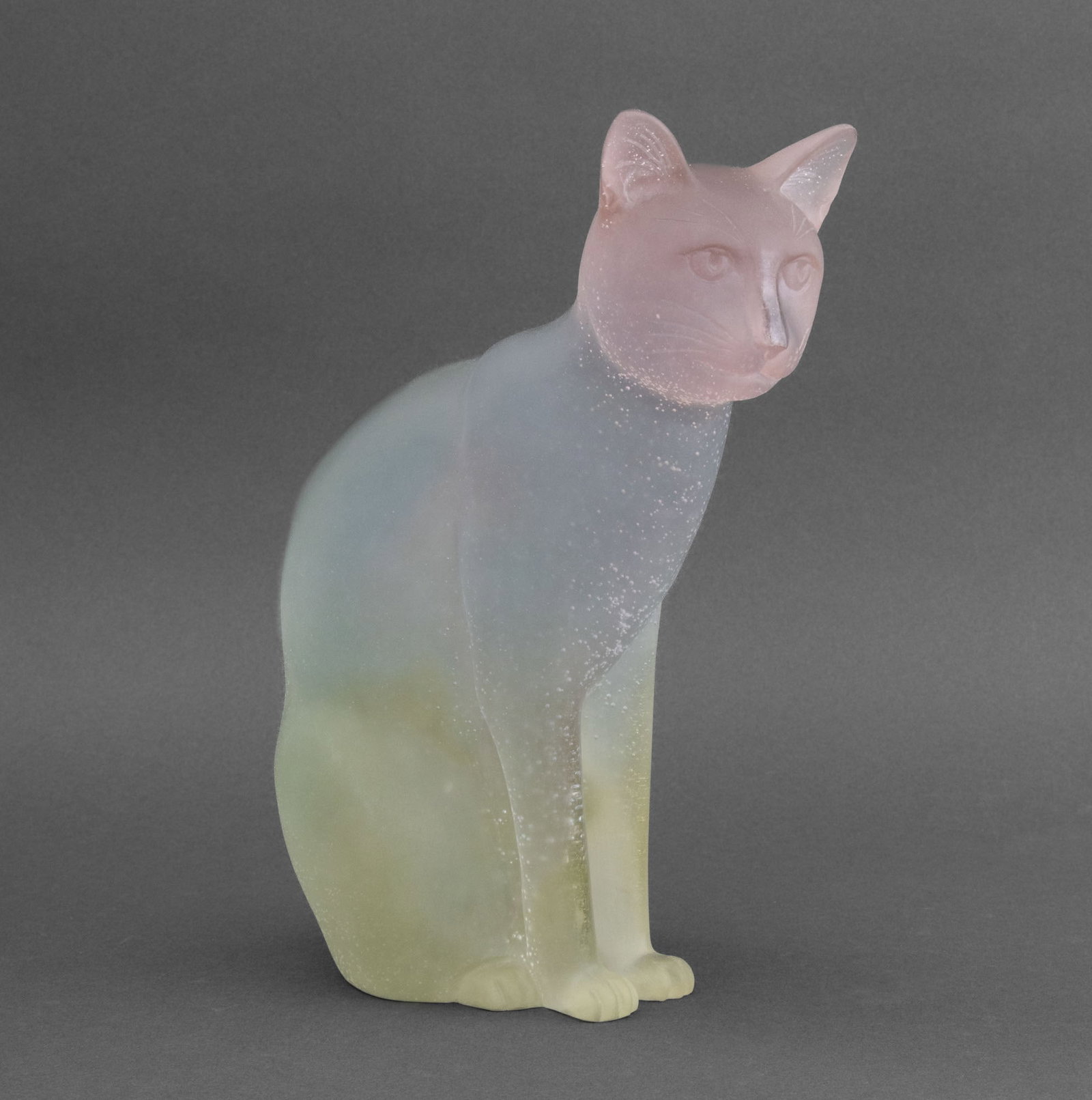 Daum Pate de Verre Glass Seated Cat Sculpture: Daum Pate de Verre Seated Cat Glass Sculpture, in pink, blue, and yellow, marked "Daum France 125" to underside. 11" H x 4.5" W x 8.75" D.Provenance: From the Fifth Avenue Estate of a Distinguished Au