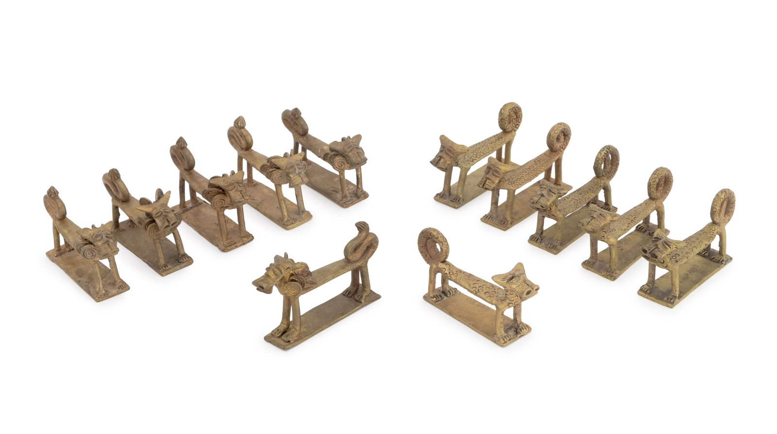 West African Lion Form Gilt Bronze Sculptures, 12: Set of Twelve West African Lion and Leopardess Form Gilt Bronze Sculptures. 2" H x 3.75" W x 1" D. Provenance: From the Fifth Avenue Estate of a Distinguished Author and Humanitarian. Keywords: Africa
