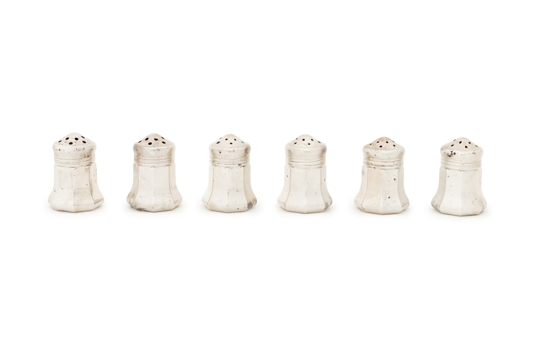Cartier Sterling Silver Salt Shakers, 6: Set of Six Cartier Sterling Silver Salt Shakers, marked "Cartier / Sterling" to underside, with fitted red case. Weight 1.42 ozt.; 1.5" H x 1" Diameter; box: 1.5" H x 9" W x 2" D. Provenance: From the