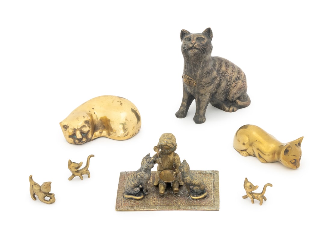 Collection of Brass Cat Figurines, 7: Collection of Seven Brass Cat Form Figurines, comprising: a gilt recumbent cat sculpture, a reclining cat statue, a figural group sculpture of two cats and a girl seated atop a rug, three diminutive s