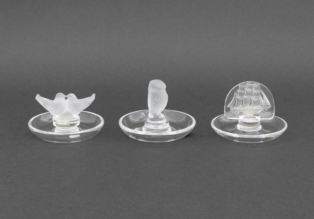 Lalique Crystal Pin Trays, 3: Collection of Three Lalique Crystal Pin Trays, each marked "Lalique France" and comprising: one with two lovebirds, one a sparrow, and one with a sailing ship motif, all with original boxes. Each box: