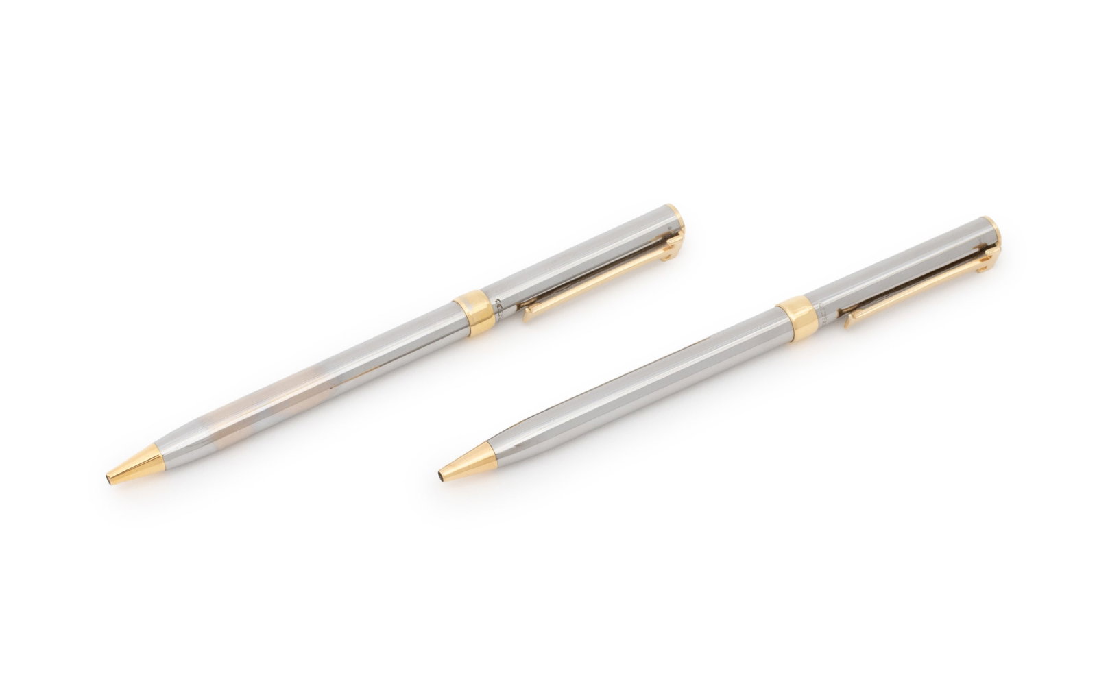 Tiffany & Co. T-Clip Ballpoint Pens, 2: Collection of Two Tiffany and Company T-Clip Ballpoint Pens, gold-tone and silver-tone bodies marked "Tiffany & Co.", together with dust bag and box. Each pen: 5" :: overall: 6.25" L x 2.5" W x 1" D. 