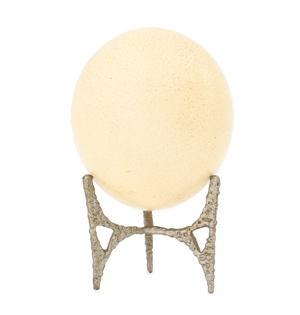 Ostrich Egg on Silvered Metal Tripod Stand: Ostrich Egg on Silvered Metal Tripod Stand. 7.75" H x 5" Diameter. Provenance: From a West End Avenue Collection. Keywords: Vintage, Sculpture, Ornament, Table decor, Birds, Ornithology, Curio, Collec
