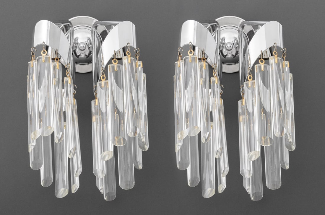 Modern Two-Light Crystal Wall Sconces, Pair: Pair of Modern Two-Light Crystal-Hung Wall Sconces, each with circular chromed back plate and two arms, the lights hung with elongated oval crystal pendants. 15" H x 9" W x 7" D. Provenance: Property