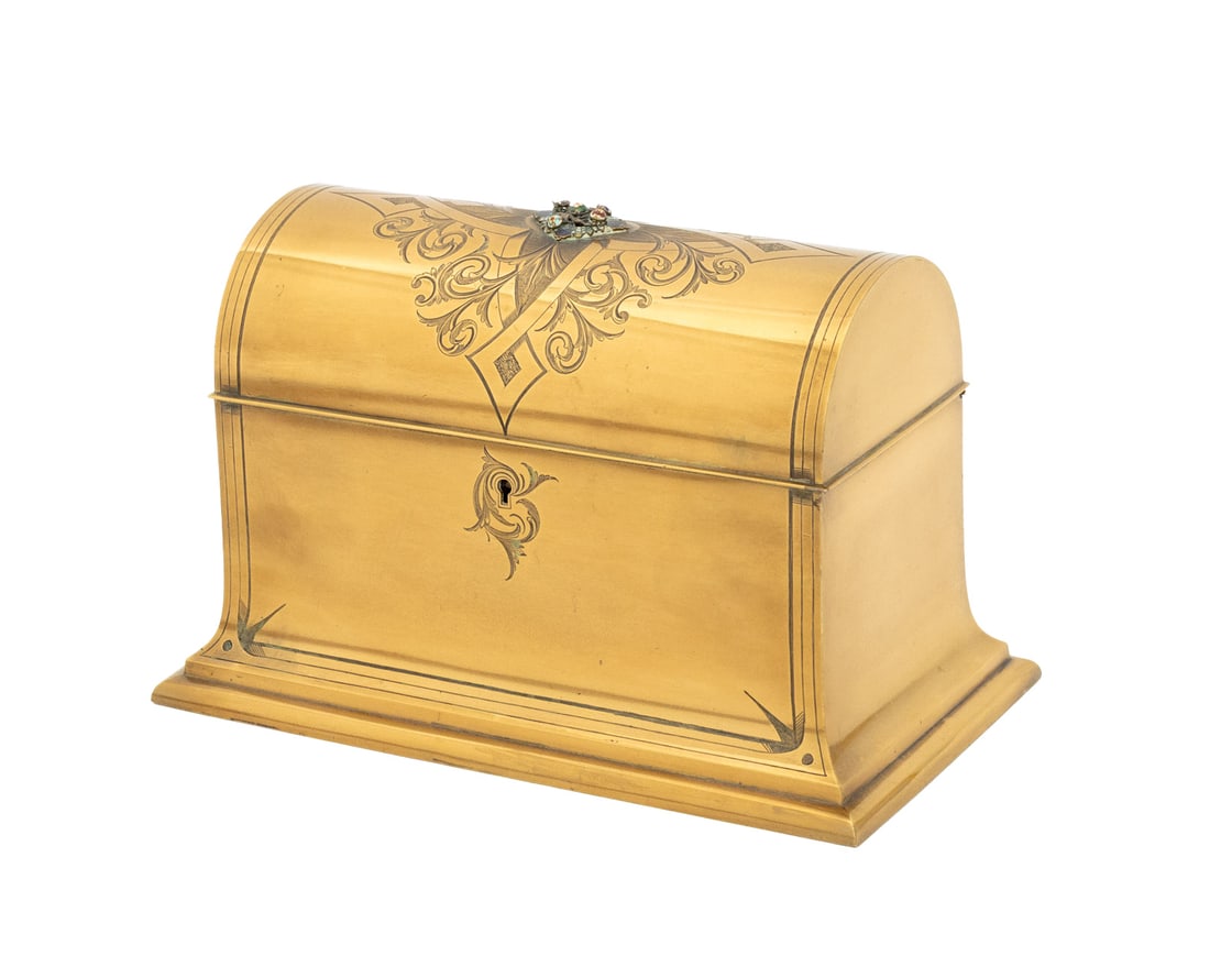French Brass Domed Casket Jewelry Box: French Brass Domed Casket Jewelry Box, with enameled flowers and incised cross and foliate motif to the lid, tan leather lined interior. 5.5" H x 8.5" W x 5" D. Provenance: From a 500 Park Avenue Esta