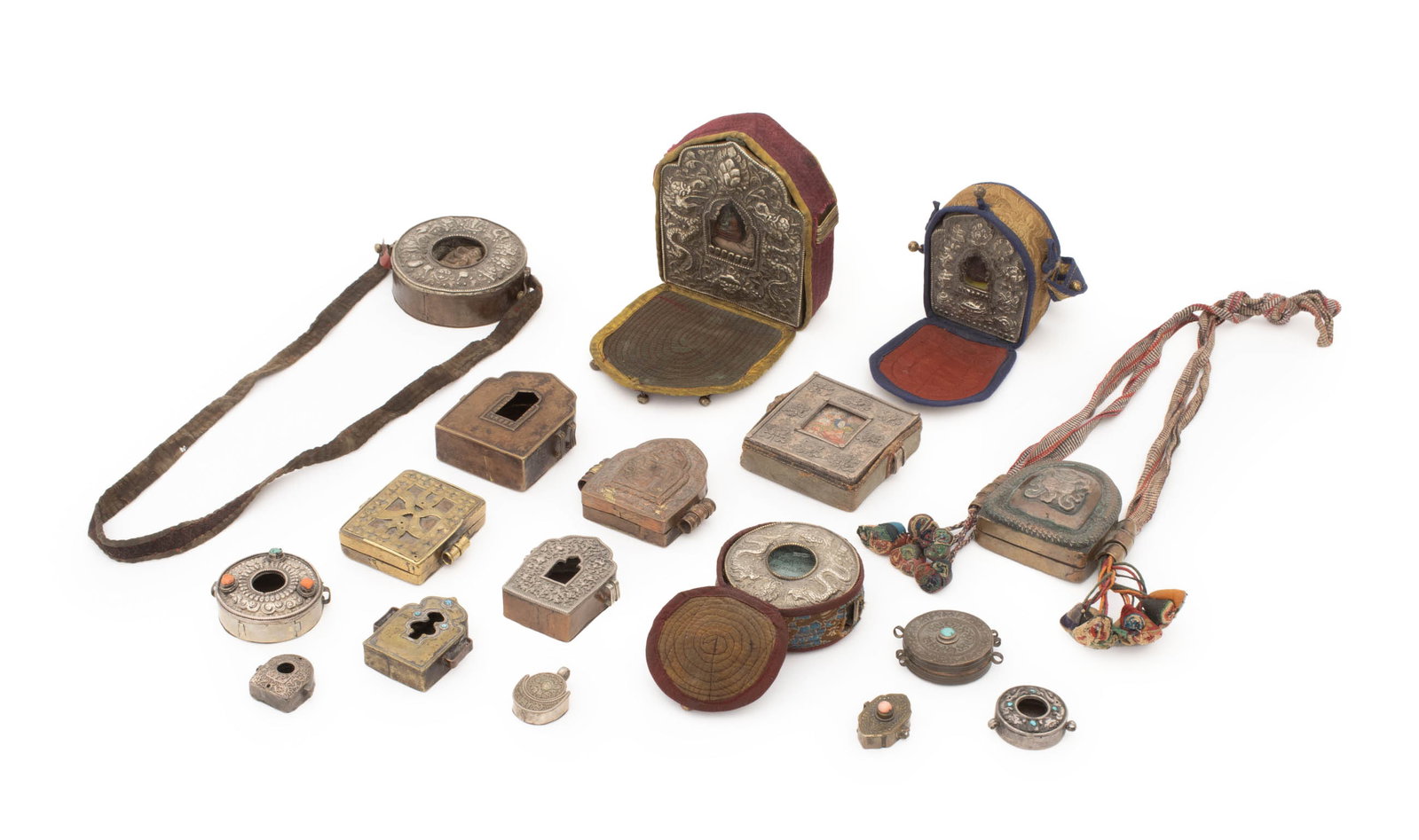 Tibetan Silver Mounted and Copper Gau Boxes, 17: Collection of 17 Tibetan Silver Mounted and Copper Gau Boxes, including: one with embossed dragon motif, carved seated Buddha mounted to interior center, with fitted silk-blend case, one with