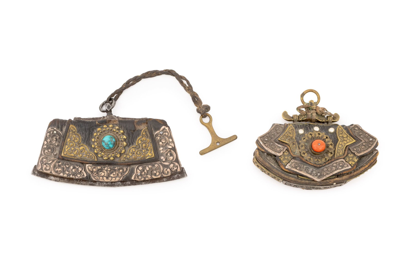 Tibetan Silver Mounted Leather Flint Pouches, 2: Two Tibetan Silver Mounted Leather Flint Pouches, one with a turquoise cabochon and the other a coral cabochon. Larger: 3.5" x 6" W. Provenance: From a New Mexico Collection. Keywords: Himalayan Arts,