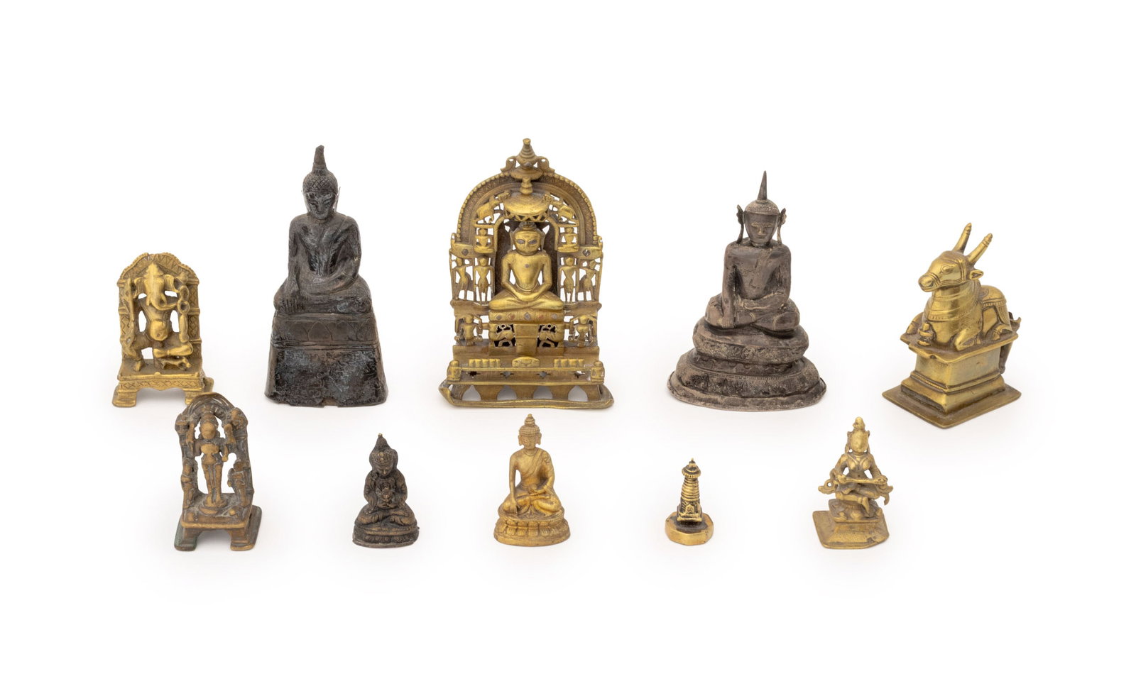 Indian & Thai Bronze and Metal Sculptures, 10: Collection of Ten Thai and Indian Bronze, Brass, and Metal Sculptures, including: Lord Ganesha, seated Buddha figures, Nandi sacred bull, a bronze stupa seal, and a brass Jain shrine. Largest: 6.5" H 