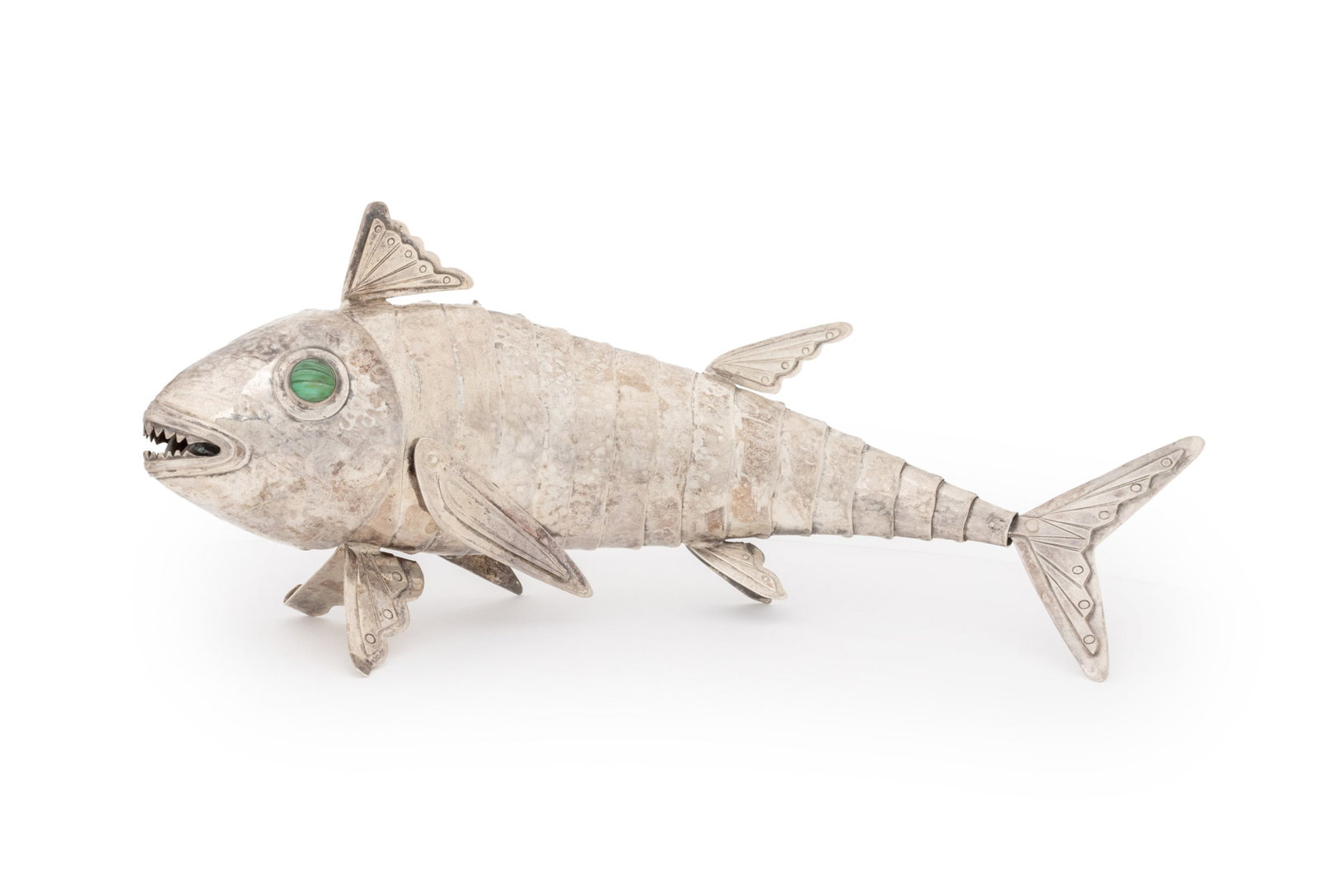 Peruvian Sterling Silver Articulated Fish: Peruvian Sterling Silver Articulated Fish Sculpture, with inset malachite glass eyes, marked "Peru / Laffi / 925" to tail fin. Weight: 9.50 ozt. inclusive; 4.5" H x 10.75" W x 2.25" D. Provenance: