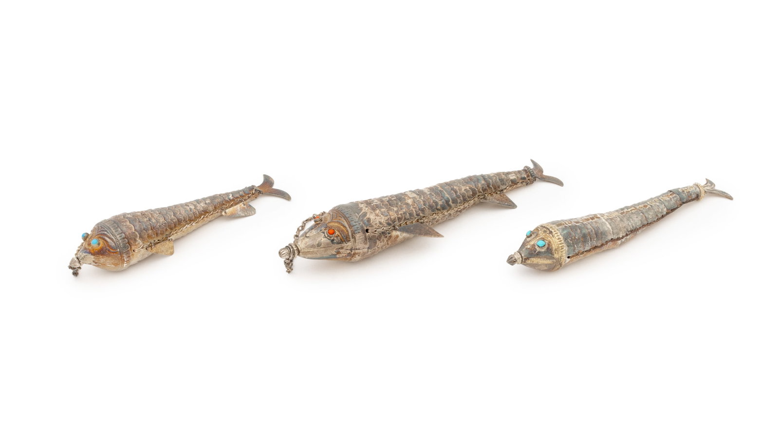 Silver Articulated Fish, 3: Collection of Three Silver Articulated Fish, two with turquoise mounted eyes and one with coral mounted eyes, unmarked. Silver tested. Weight: 7.34 ozt; 8" L x 1.75" Diameter. Provenance: From a New