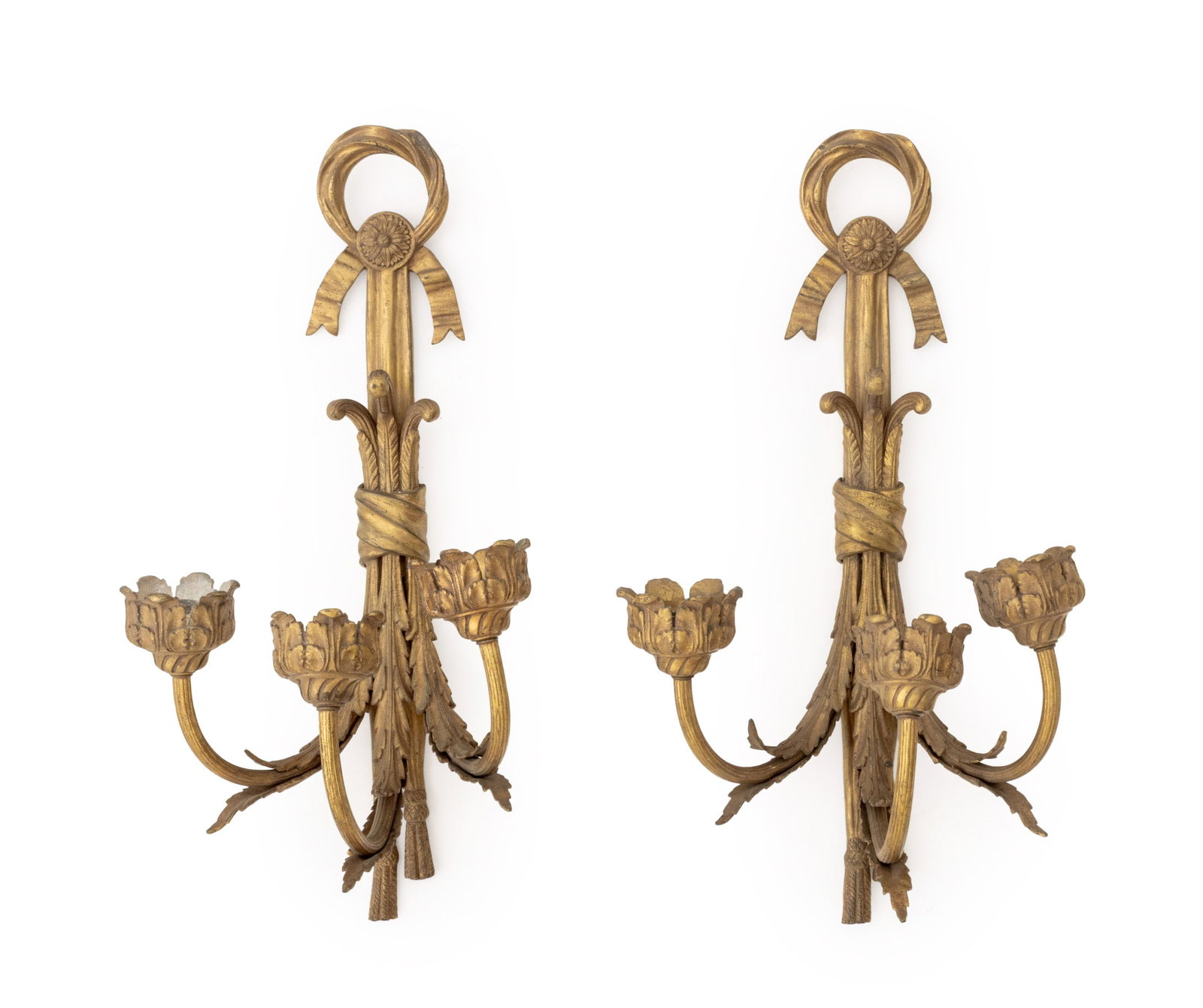 Louis XVI Style Gilt Bronze Wall Sconces, Pair: Pair of Louis XVI Style Gilt Bronze Wall Sconces, each with three branches, acanthus leaf form candleholders, and drapery and tassel mounting. 21.25" H x 10" W x 7.25" D. Provenance: From an East 79th