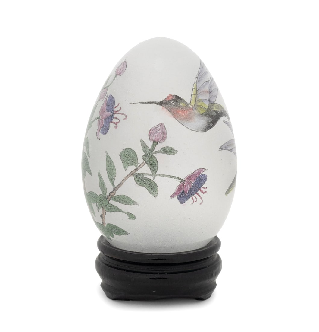 Hummingbirds & Flowers Reverse Painted Glass Egg: Hummingbirds Amongst Flowers Reverse Painted Glass Egg Sculpture, with ebonized wood fitted stand. Overall: 4" H x 2.25" Diameter. Provenance: From an Upper East Side Estate. Keywords: Paintings, Stat
