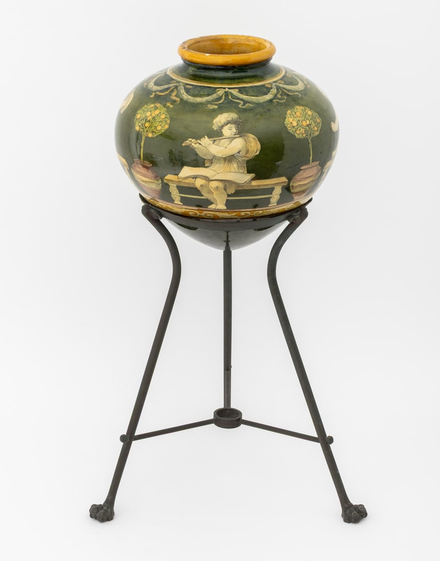 Italian Neoclassical Style Glazed Ceramic Vase: Italian Neoclassical Style Glazed Ceramic Vase, depicting classical figures playing instruments and lemon trees on a green ground with tan trim mounted on a patinated brass tripod stand with three