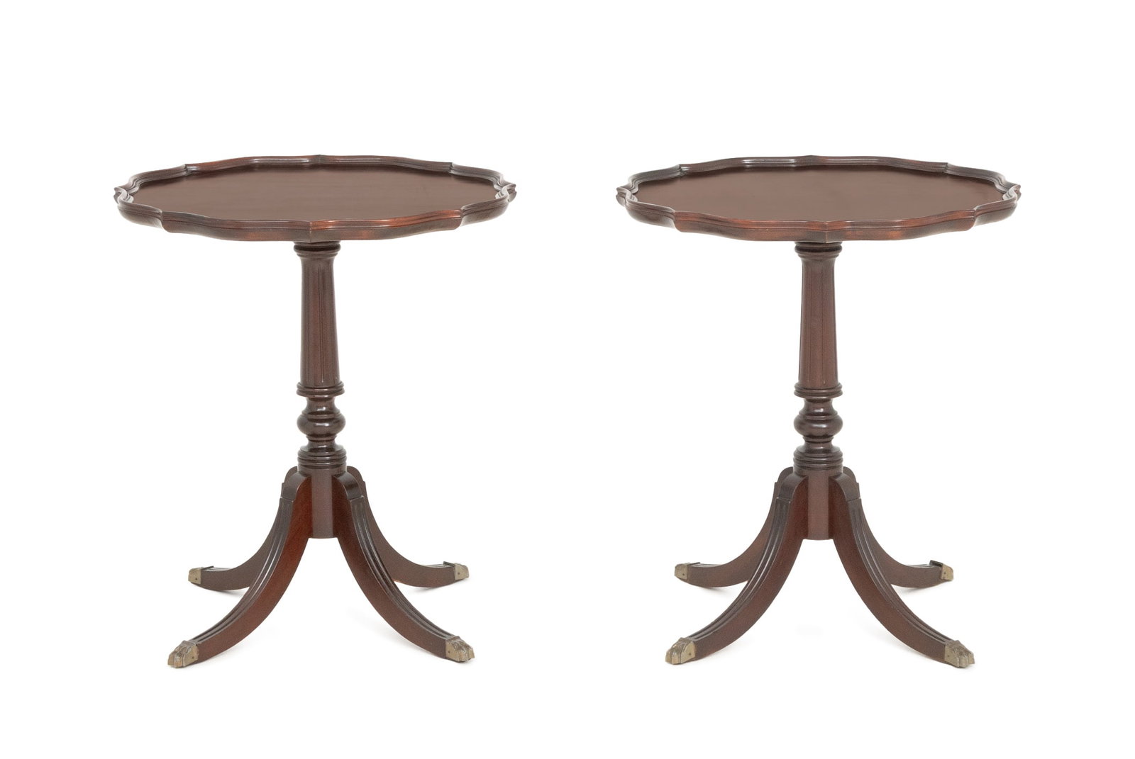 Regency Style Mahogany Pie Crust Tables, Pair: Pair of Regency Style Mahogany Pie Crust Edge Side Tables, each on turned pedestal support and four fluted feet with brass paw feet. 27" H x 24" Diameter. Provenance: From an East 79th Street Estate. 