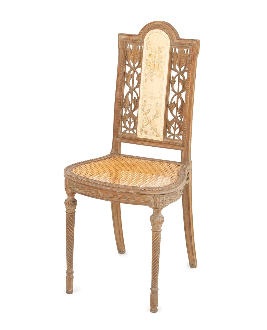 Louis XVI Silk Embroidery Panel Chair, ca. 1900: Louis XVI Style Silk Embroidery Panel Side Chair, circa 1900, with carved scrolling floral motif reticulated back and cane paneled seat. 36.5" H x 16.75" W x 18" D; seat: 17.75" H. Provenance: From a