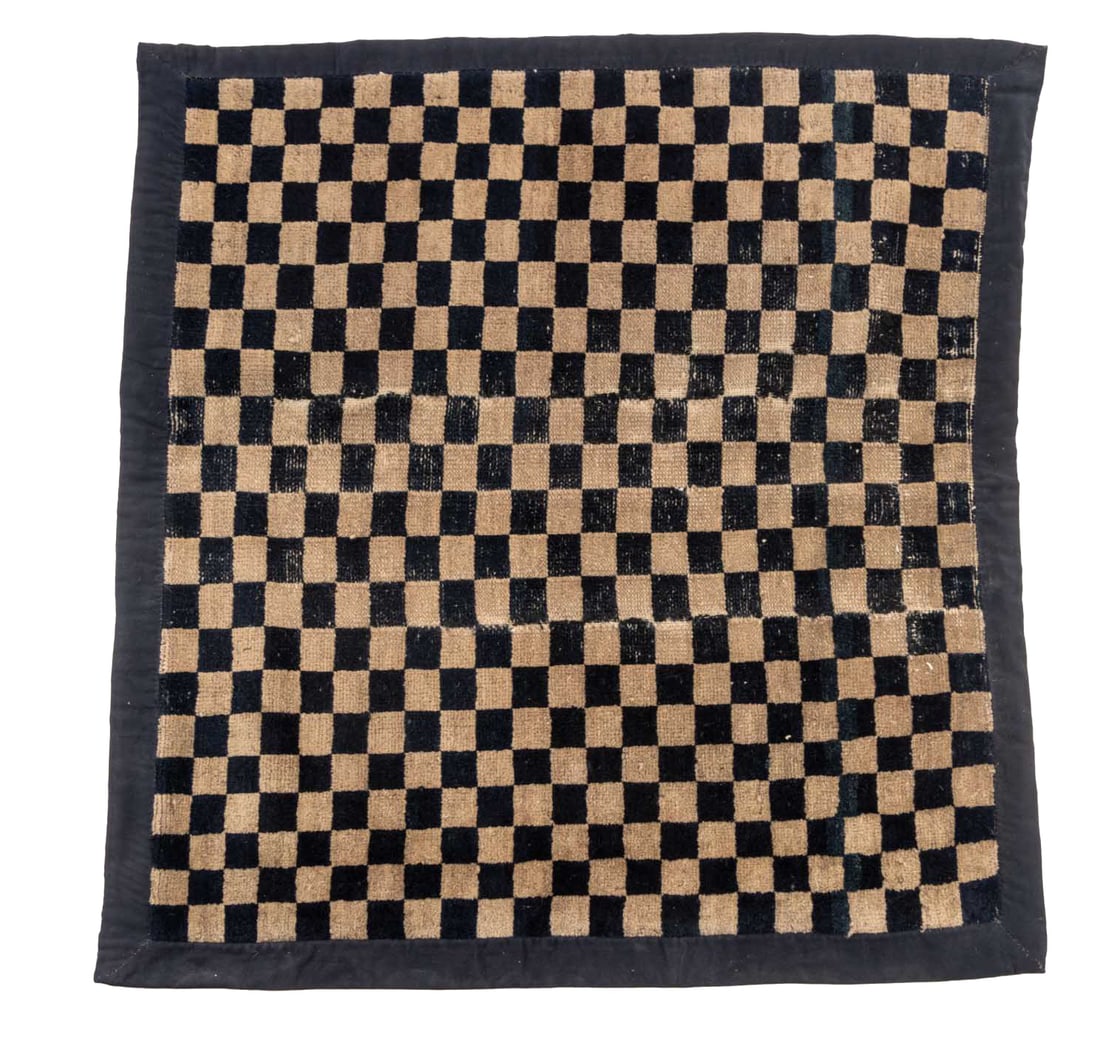 Tibetan Black and Tan Checkerboard Rug, 3' x 2' 9": Tibetan Black and Tan Checkered Prayer Rug. 3' L x 2' 9" W. Provenance: From the Estate of Joseph Lawrence Gardella. Keywords: Himalayan Art, Nepal, Asian Art, Textiles, Meditation mat, Carpets, Wool