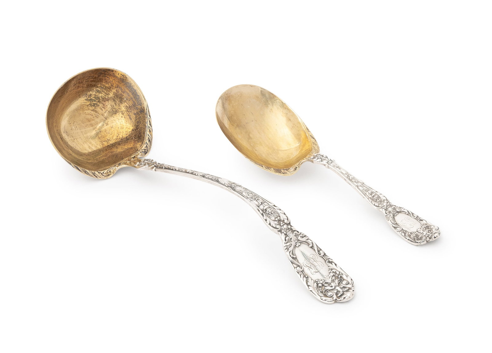 American Sterling Silver Serving Flatware, 2 Pcs.: Two American Sterling Silver Serving Flatware Pieces, struck with marks for Gorham, early 20th century, in the "Florentine" pattern with gold-washed bowls, comprising: ladle and berry spoon. Weight: 1